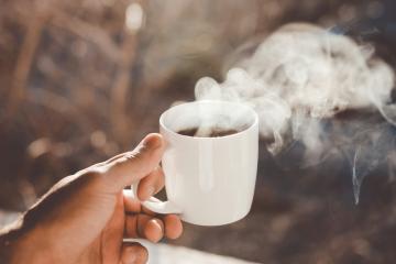 Cup of tea being held by a hand